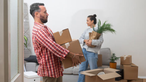 A man and woman packing boxes to downsize for their new home.