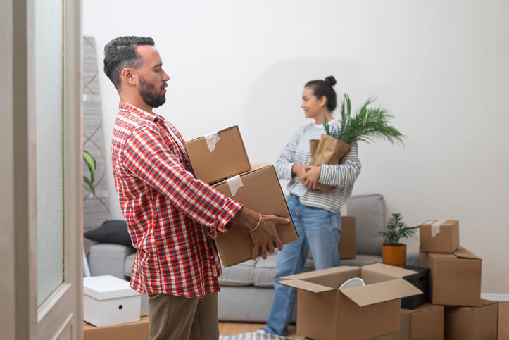 A man and woman packing boxes to downsize for their new home.