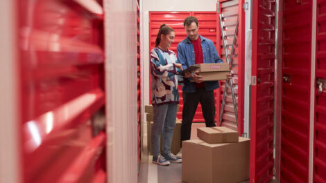 A man and woman moving belongings into a self storage unit.
