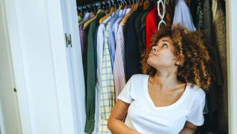 Woman looking at clothes in the closet
