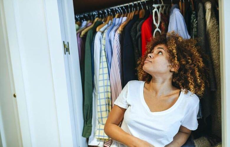 Woman looking at clothes in the closet