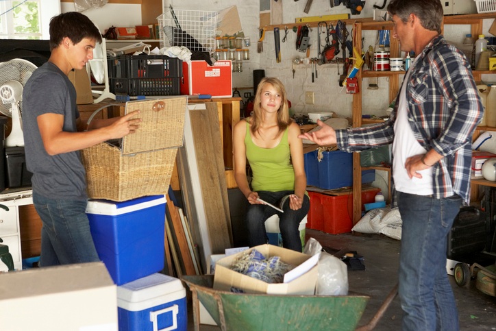 A family organizing a cluttered garage.