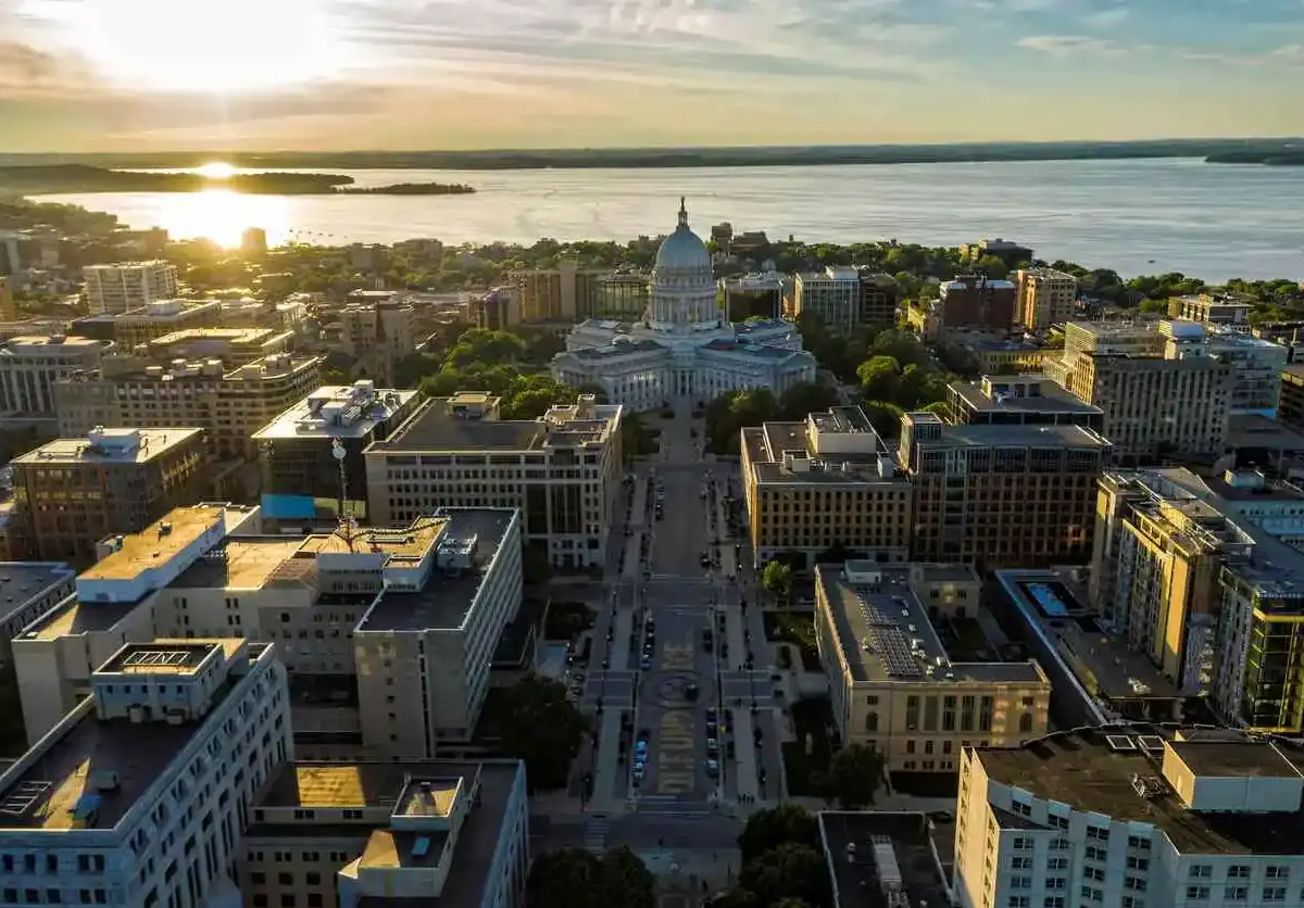 Aerial sunset view of downtown Madison, Wisconsin, with the State Capitol building centered.